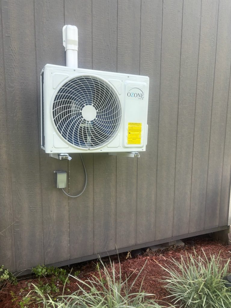 Ozone Spirit mini split condenser installed on a wall bracket at a Lafayette, LA home